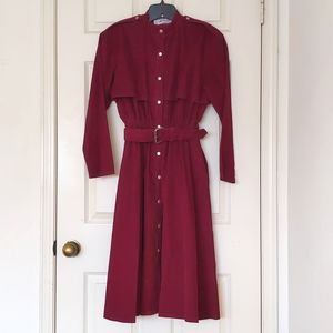 Woman's Burgundy corduroy long coat with snap buttons and belt.